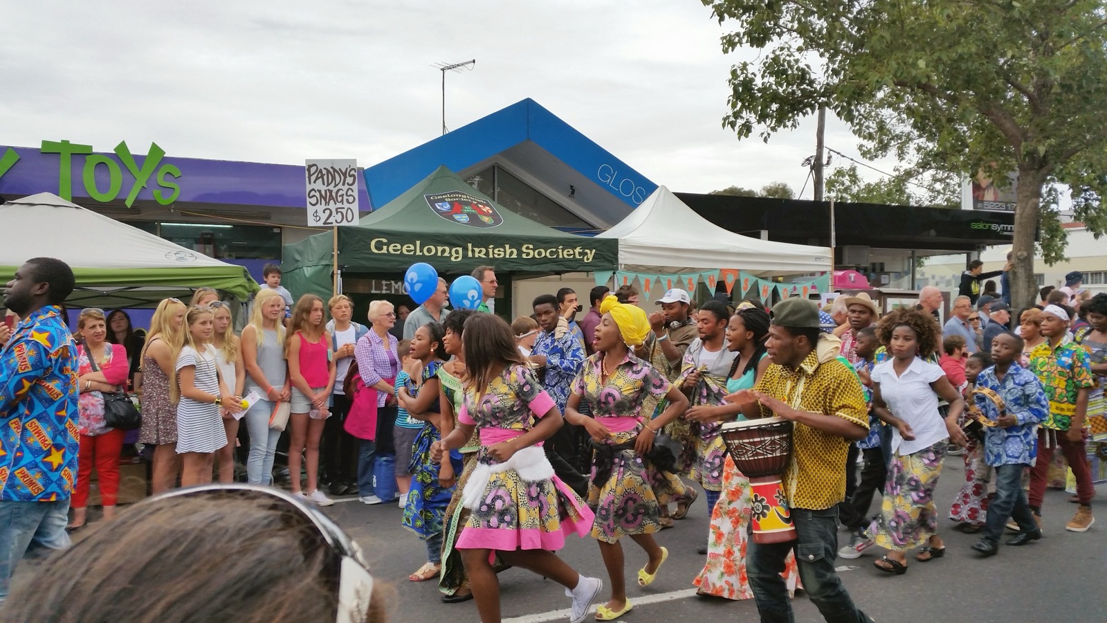 African diaspora dancers and drummers in a street parade at a Geelong community festival, Victoria, Australia