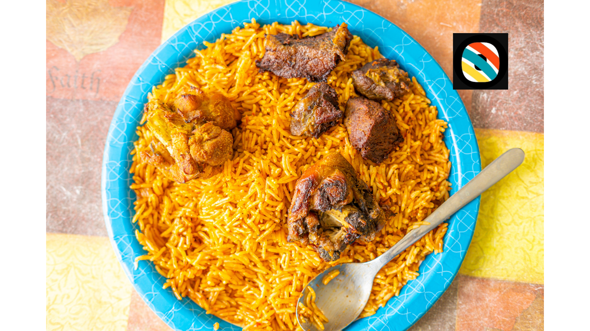 Nigerian jollof rice served with fried meat, peppers and greens