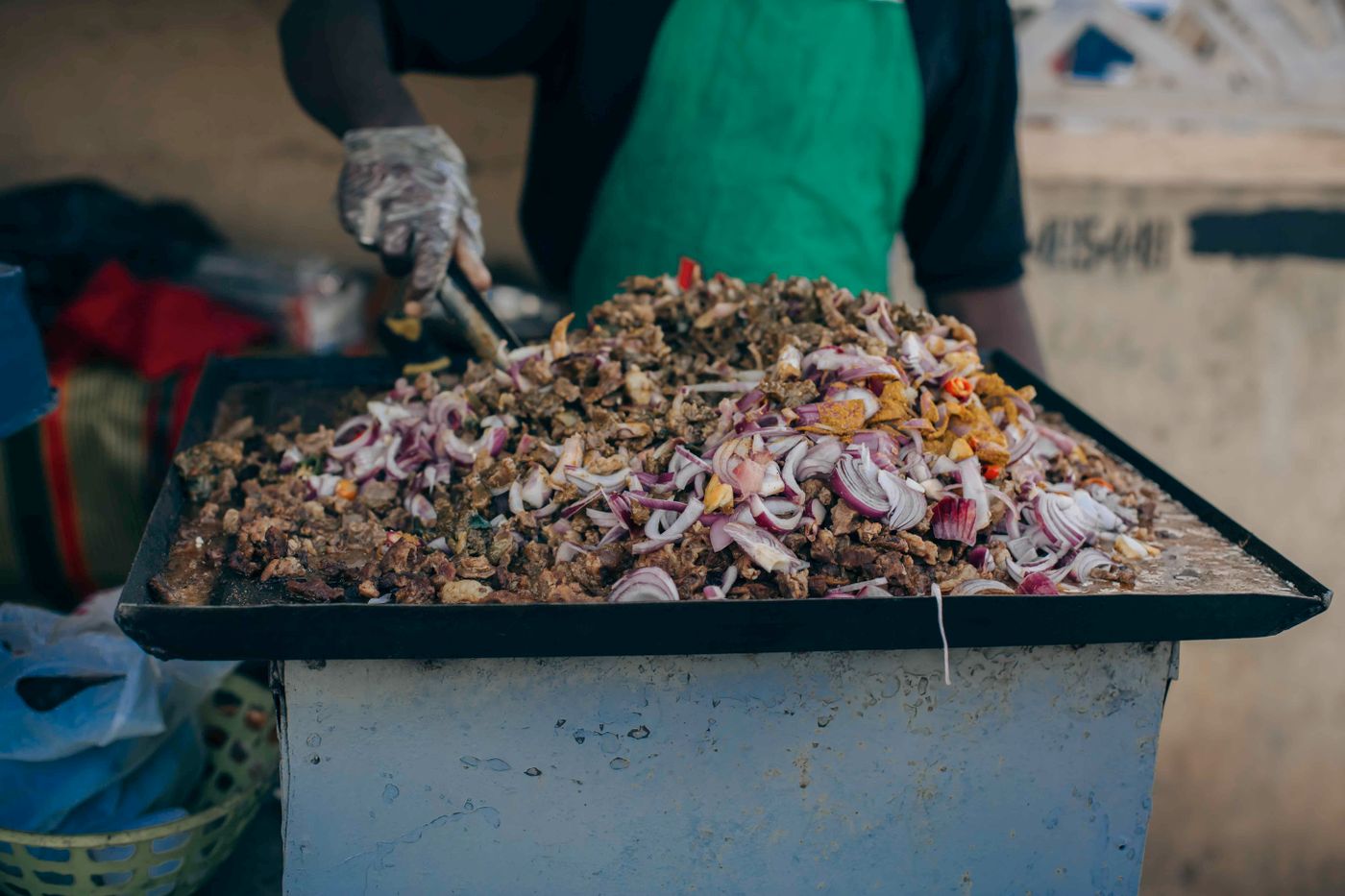 A cook preparing food at a market